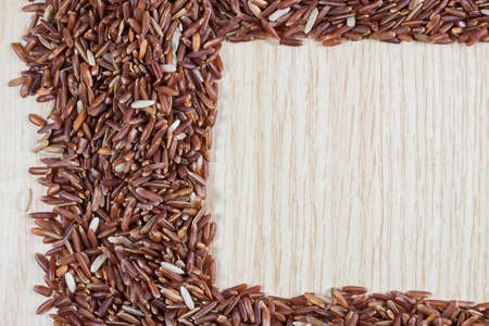 Rice berry on a wooden background.の写真素材