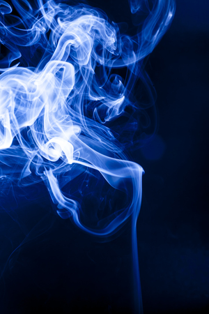 Motion blue smoke on black background.の写真素材