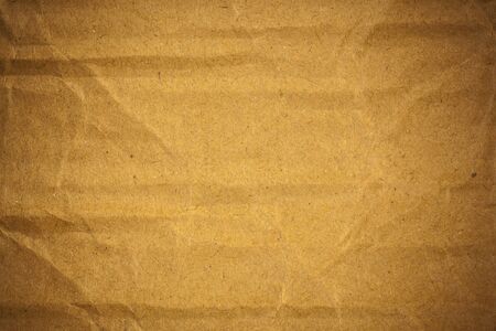 Textured crumpled brown cardboard paper background.の写真素材
