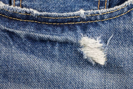 Blue torn denim jeans texture.の写真素材