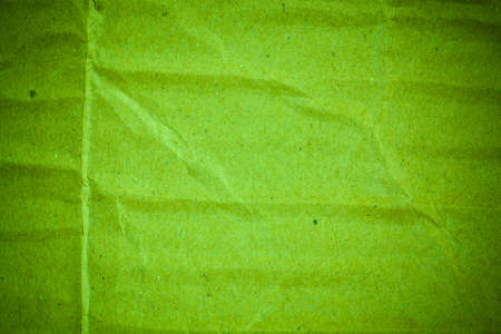 Textured crumpled green cardboard paper background.の写真素材