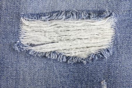 Blue torn denim jeans texture.