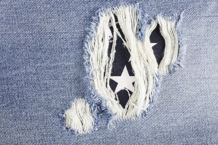 Blue torn denim jeans texture.