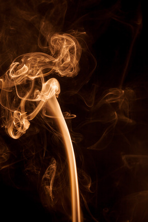 Movement gold smoke on black background.の写真素材