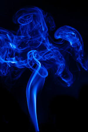 Movement blue smoke on black background.の写真素材
