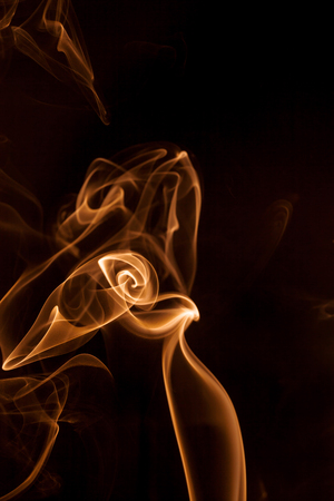Movement gold smoke on black background.の写真素材