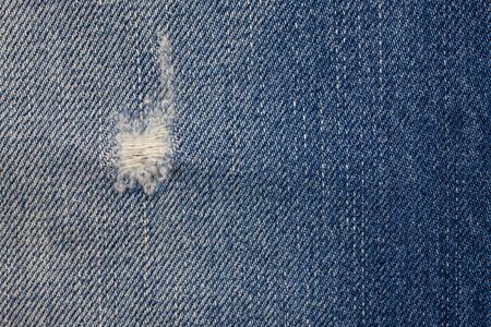 Blue torn denim jeans texture.