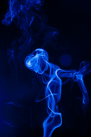 Movement blue smoke on black background.の写真素材