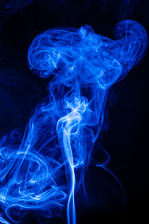 Movement blue smoke on black background.の写真素材
