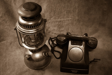 Still life Vintage black phone, Old hurricane lamp sepia toneの写真素材