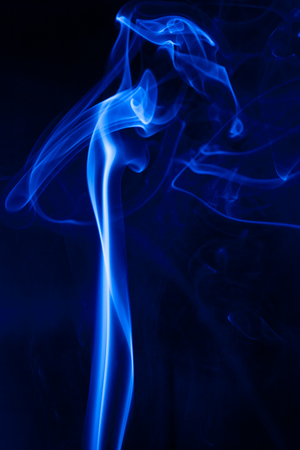 Movement blue smoke on black background.の写真素材