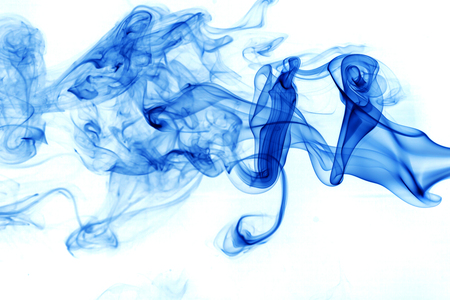 Blue smoke movement on white background.の写真素材