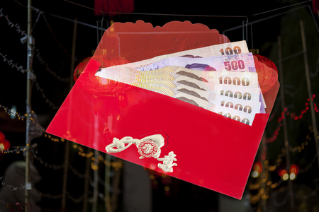 Chinese new year money in red envelopes gift on white background.の写真素材