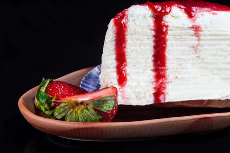 Crepe cake with strawberry sauce and fresh strawberries.の写真素材