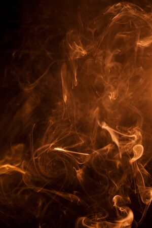Gold smoke on a black backgroug.の写真素材