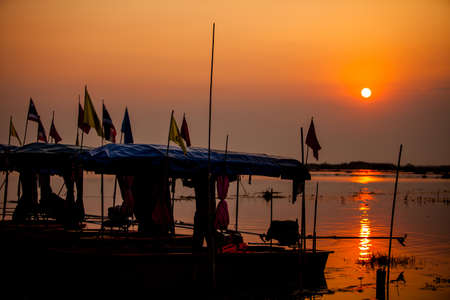 Boats in lake at sunset background.の写真素材