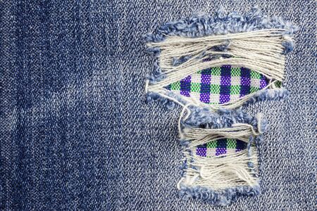 Jeans torn denim texture.