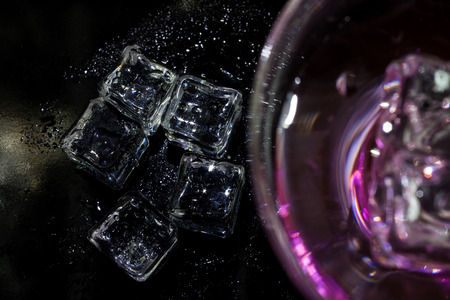 Cocktail of bright colors on a black background.の写真素材