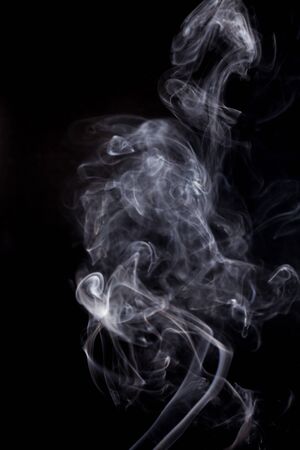 Blue smoke on a black background.の写真素材