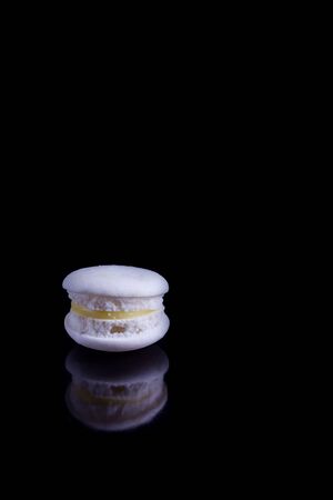 White french macaroons on a black background.の写真素材