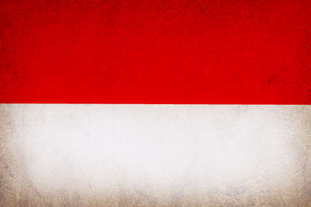 Flag of Republic of Indonesia on old wall texture background.の写真素材