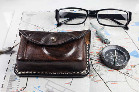 Compass, camera, glasses on map for tourists.の写真素材