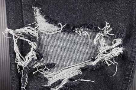 Old black jeans torn denim texture vintage.の写真素材