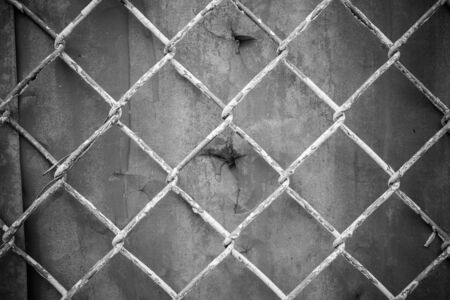 Chain fence, Steel mesh fence, Steel wire mesh on rusty galvanized background, Rusty backgroundの写真素材