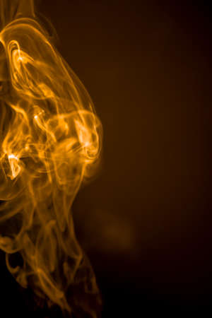 Gold smoke motion on black background.の写真素材