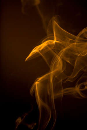Gold smoke motion on black background.の写真素材