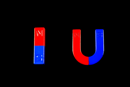 Magnetic red and blue on a black background.の写真素材