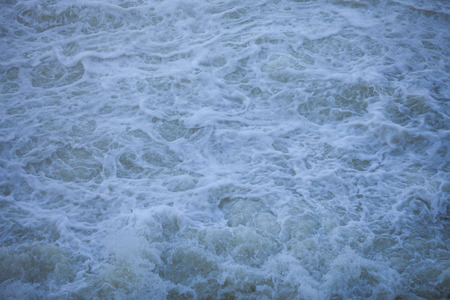 Water flowing from the open sluice gates of dam.の写真素材