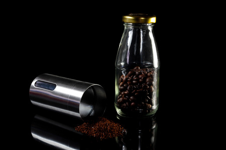 Freshly ground coffee beans with grinder.の写真素材