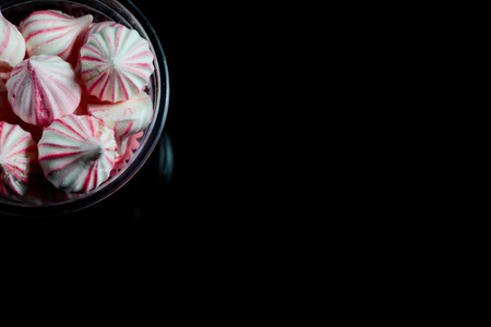 Rainbow meringue homemade on black background.の写真素材