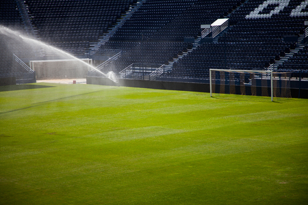 Water jets sprinkling a football Stadium.の写真素材