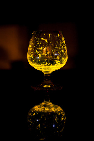 Glass of whiskey glow in the dark.の写真素材