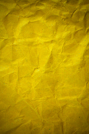 Texture crumpled yellow paper background.の写真素材
