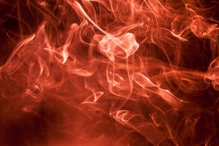 Red smoke on a black background.