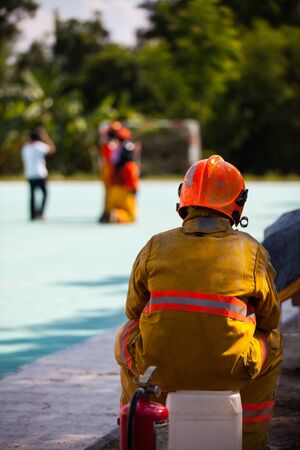 Firefighter with fire and suit for protect fire fighter for training firefighters.の写真素材