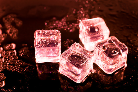 Red ice cubes and water drop background.の写真素材