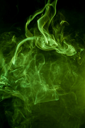 Green smoke on a black background. smoke on a black background.の写真素材