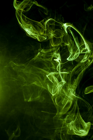 Green smoke on a black background. smoke on a black background.の写真素材