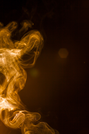 Gold smoke on black background.の写真素材