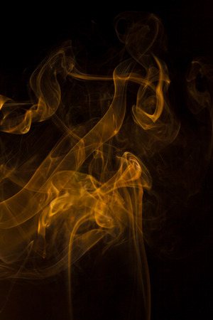 Gold smoke on black background.の写真素材