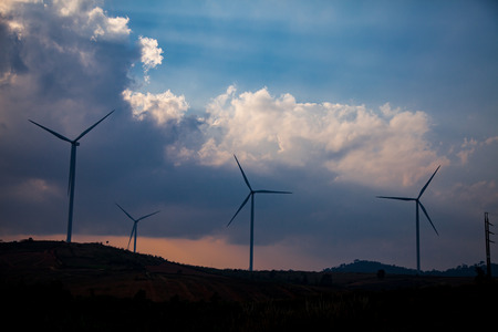 Wind turbine farm of silhouette at sunset.