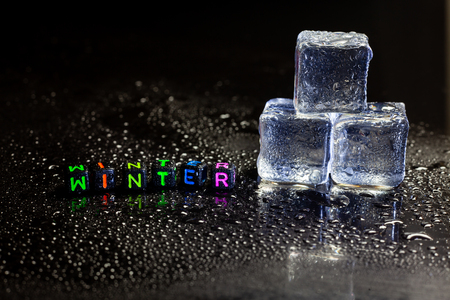 ice cubes reflection and Winter on black table background.の写真素材