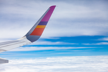Aircraft Wing on blue sky and white clouds background.の写真素材