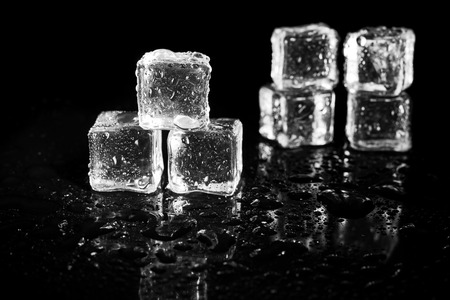 ice cubes reflection on black table background.の写真素材