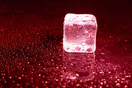 ice cubes on a reflections red light.の写真素材
