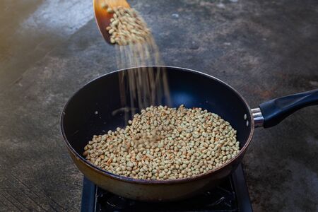 Traditional roasting coffee at home,  freshly roasted coffee beans.の写真素材